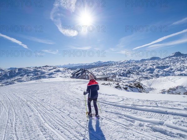 Snowshoe hiker in winter landscape in the high mountains