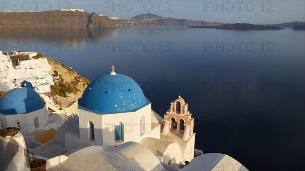 View down to white church with blue dome