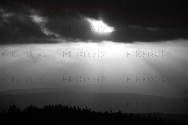 A Dramatic Sunset in the Evening with Clouds over a Valley in the Forest
