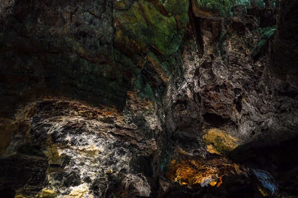 Colourfully illuminated areas of the Cueva de los Verdes