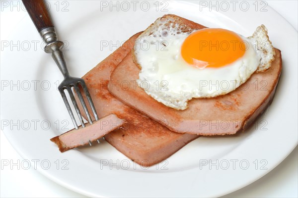 Two slices of meat loaf with fried egg on plate