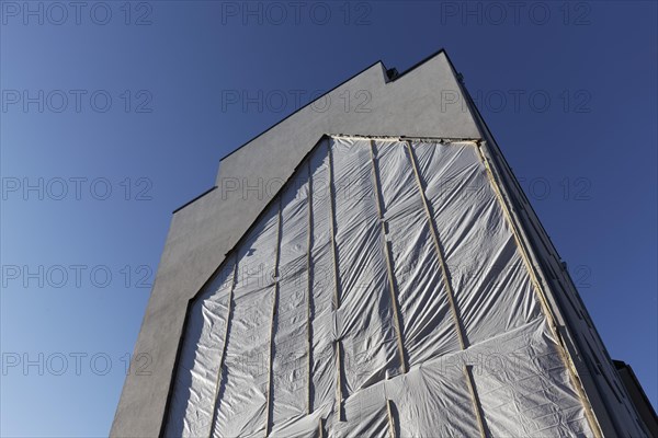 Fire wall with outline of a demolished house