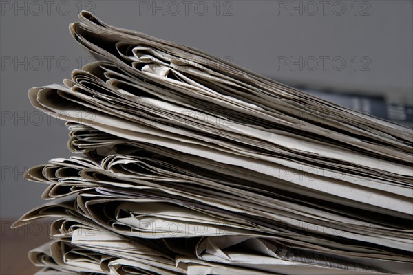 Pile of newspapers read out in the household