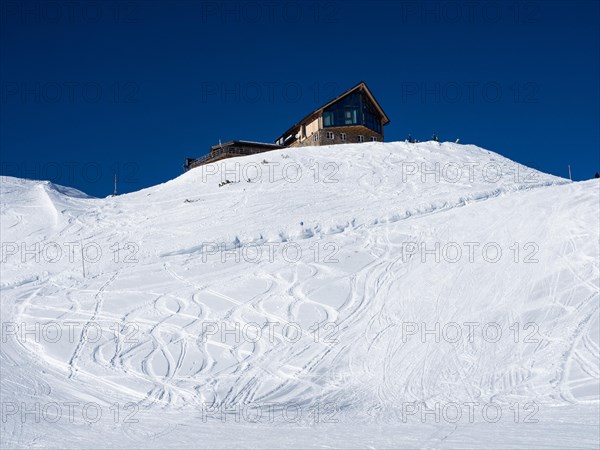 Snowy slope with traces of skiers in the snow