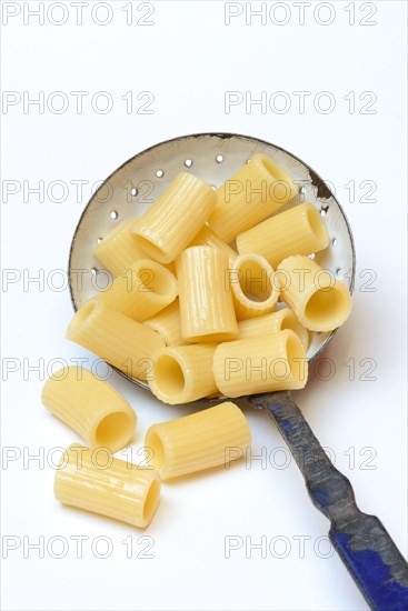 Cooked rigatoni with strainer ladle
