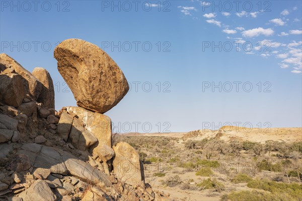 Balancing rock high above the dry bed of the Ugab river