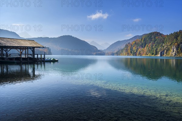 Lake Alpsee with boathouse in autumn