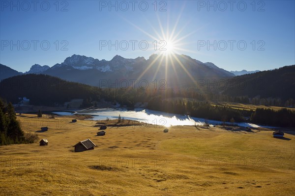 Sunrise over Karwendel mountain range with frozen lake