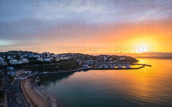 View over Torquay and Torquay Marina from a drone in sunrise time