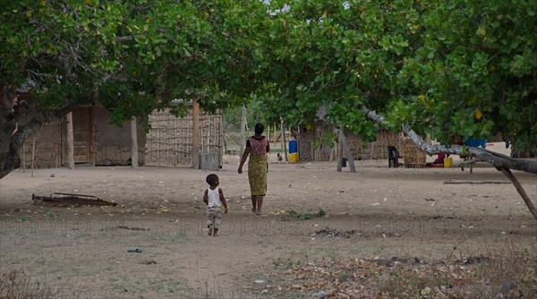 A woman and a small child in a village in Gaza Province