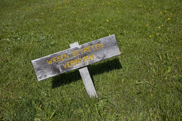 Alpine pasture Wooden sign Meadow no trespassing