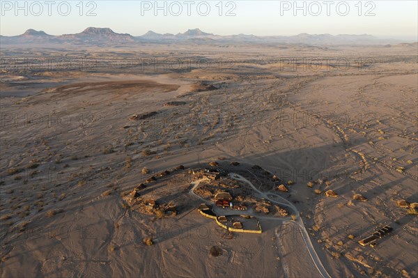 The Doro Nawas Camp and arid desert plains at the edge of the dry river bed of the Aba-Huab river