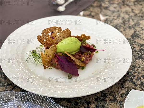 Avocado dip with toasted bread and salmon tartare