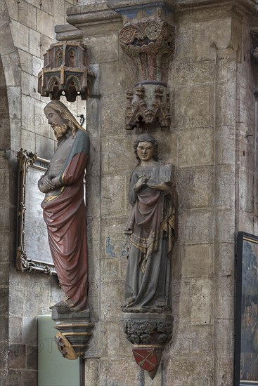 Coloured sculptures of the Man of Sorrows on the left and holy St. Matthew on the right