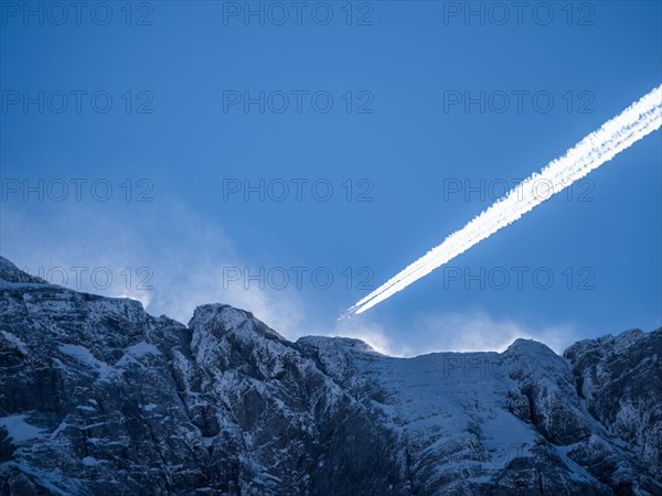 Plane over summit of the Hochtor Group in morning light