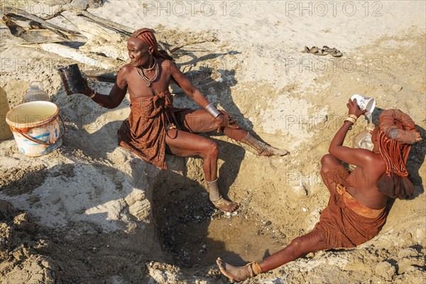 Himba women collecting water at a water hole