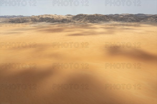Sandy desert plain and bare mountain ranges