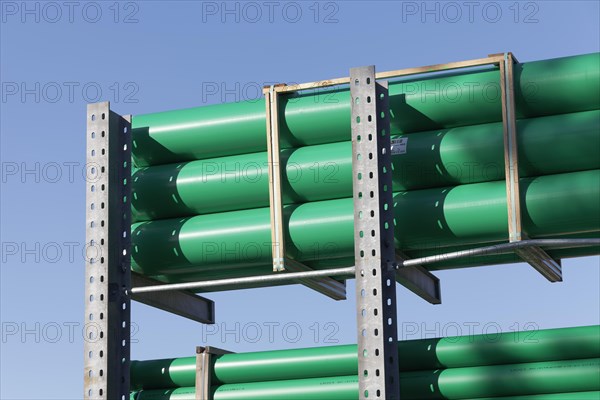 Green plastic sewage pipes in a warehouse for building material