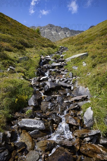 Mountain stream with waterfall in the rear Passeier Valley