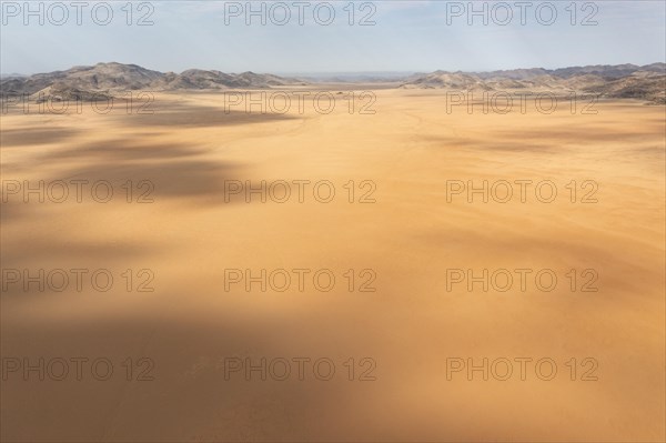 Sandy desert plain and bare mountain ranges