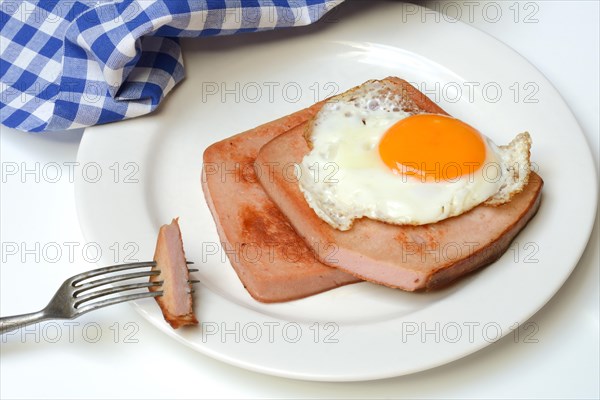Two slices of meat loaf with fried egg on plate