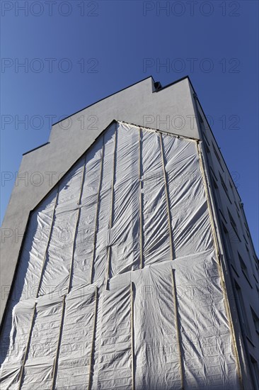 Fire wall with outline of a demolished house