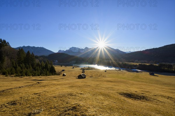 Sunrise over Karwendel mountain range with frozen lake