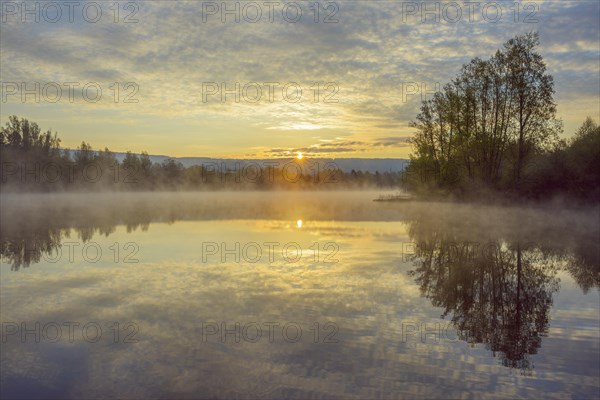 Lake with morning mist at sunrise