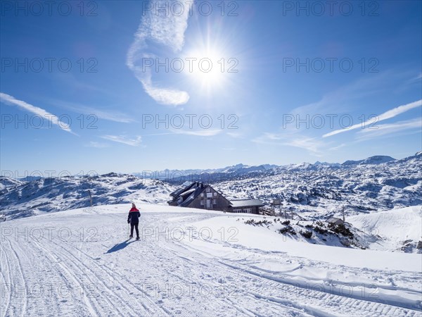 Snowshoe hiker in winter landscape in the high mountains
