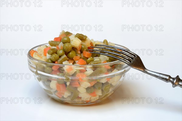 Ingredients for Russian salad in bowl