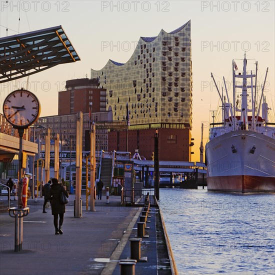 Elbe Philharmonic Hall with the museum ship Cap San Diego at sunrise