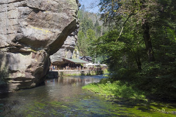 Resting place at the log cabin and rock walls in the Kamenice valley