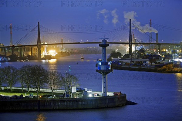 Radar tower with water level indicator in front of the Koehlbrand Bridge in the evening