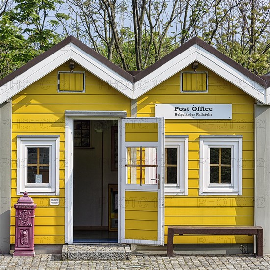 Yellow lobster shack with red letterbox