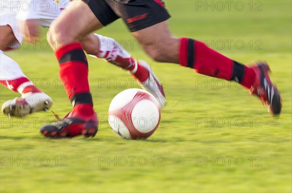 Legs of two running football players