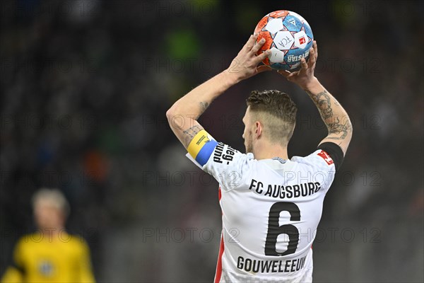 Jeffrey Gouweleeuw FC Augsburg FCA with captain's armband in the national colours of Ukraine
