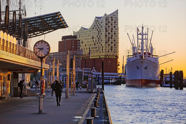 Elbe Philharmonic Hall with the museum ship Cap San Diego at sunrise