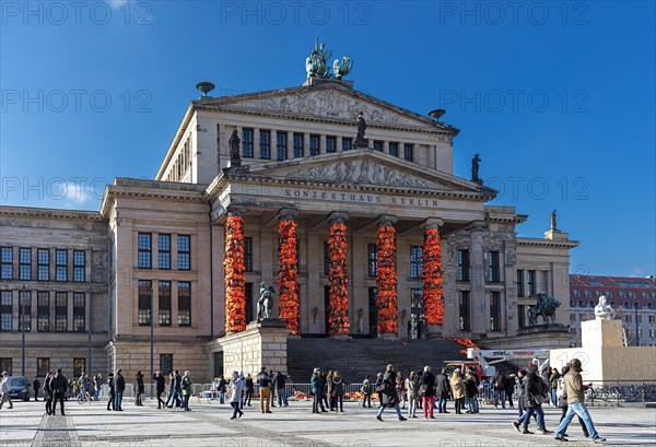 Red life vests of refugees on the pillars of the concert hall
