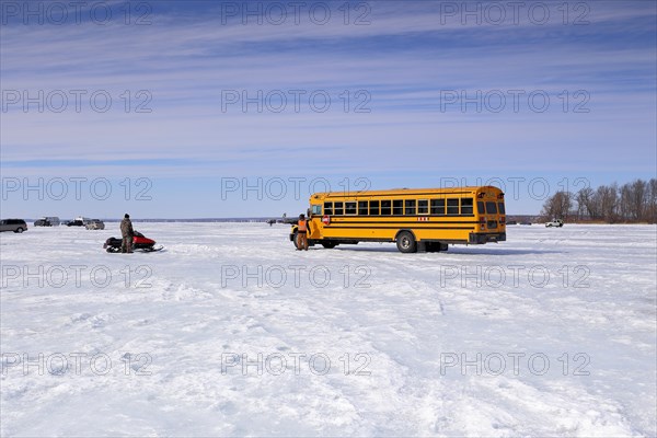 Yellow school bus on the frozen Lawrence River