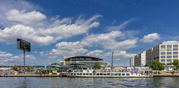 Passenger boats on the Spree at the Mercedes Benz Sales Headquarters and the Mercedes Benz Arena