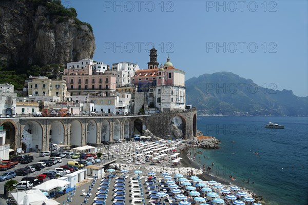 Beach with umbrellas and parking