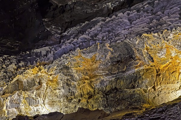 Colourfully illuminated areas of the Cueva de los Verdes