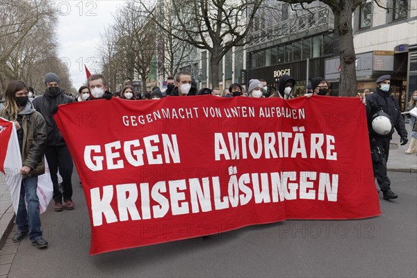 Demonstrators of the Left Party carry banner Against authoritarian crisis solutions