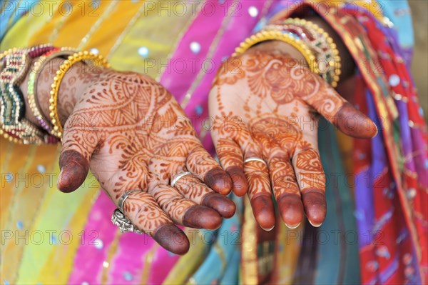 Festive henna painting of the hands of an Indian woman