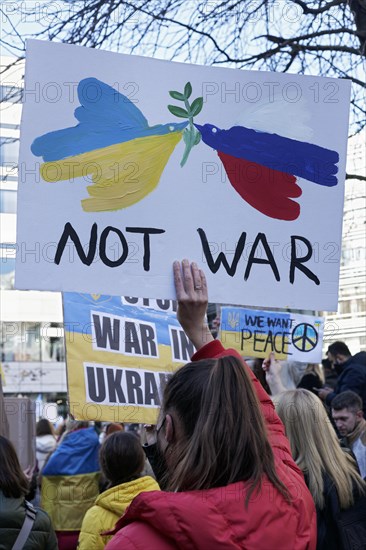 Female protestor holding protest poster against the Russian invasion of Ukraine