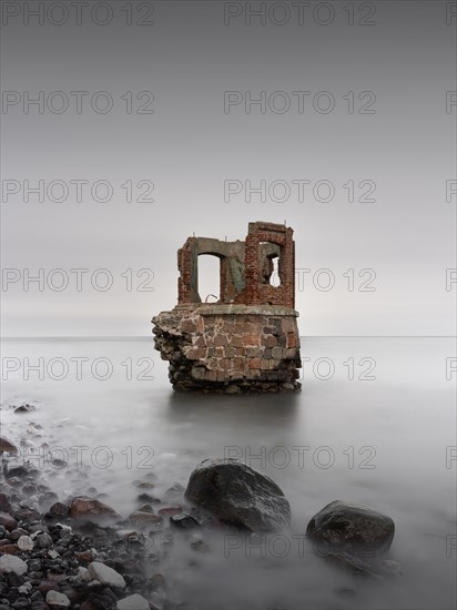 Old tide gauge house on the beach near Kap Arkona on the German island of Ruegen