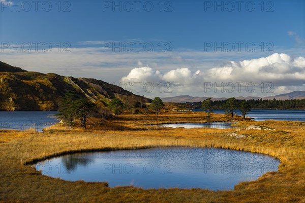 Lough Cloonee with cloudy sky in autumn landscape