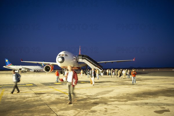 Landed airline with passengers on tarmac at airport