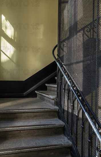 Staircase and grid on a historic lift in an old factory