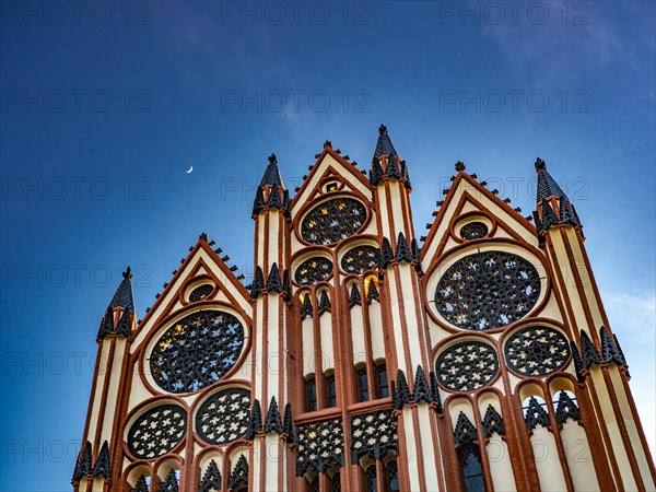 The moon shines over the facade of the town hall